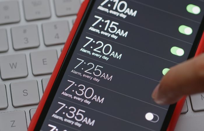 smartphone displaying several alarms set
